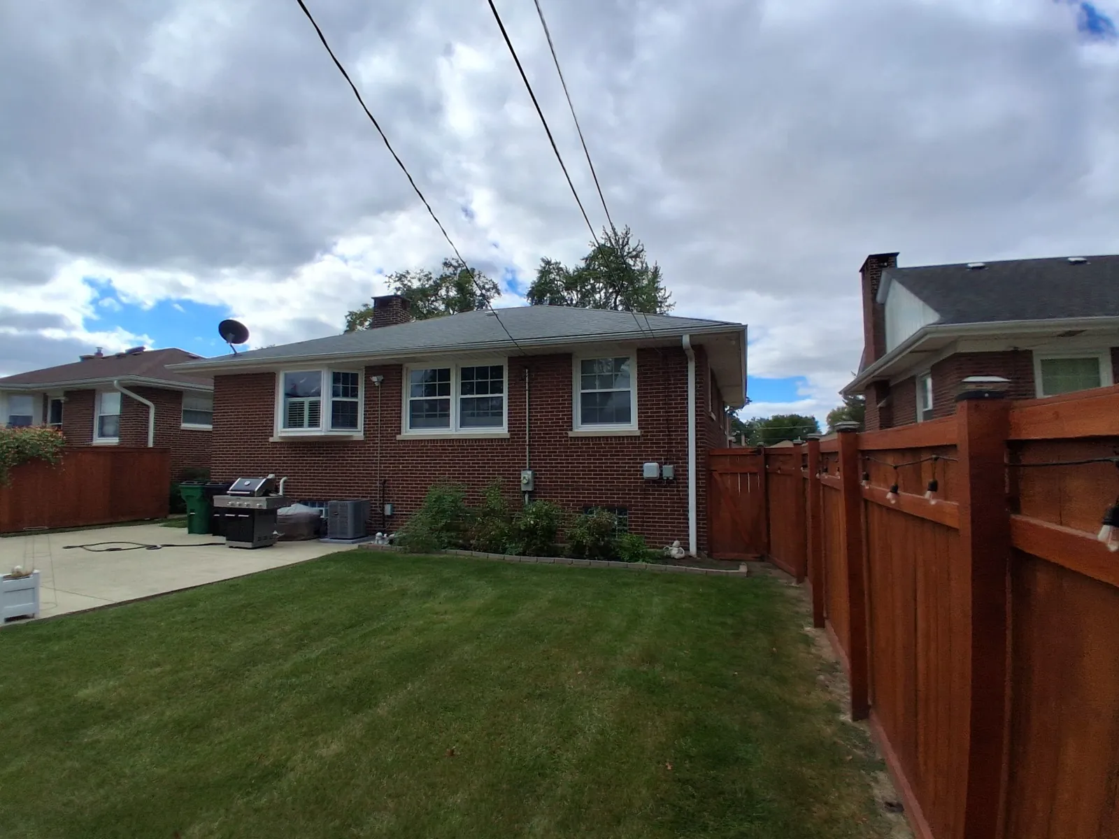New gray asphalt architectural shingle roof on a brick home in Westchester, IL