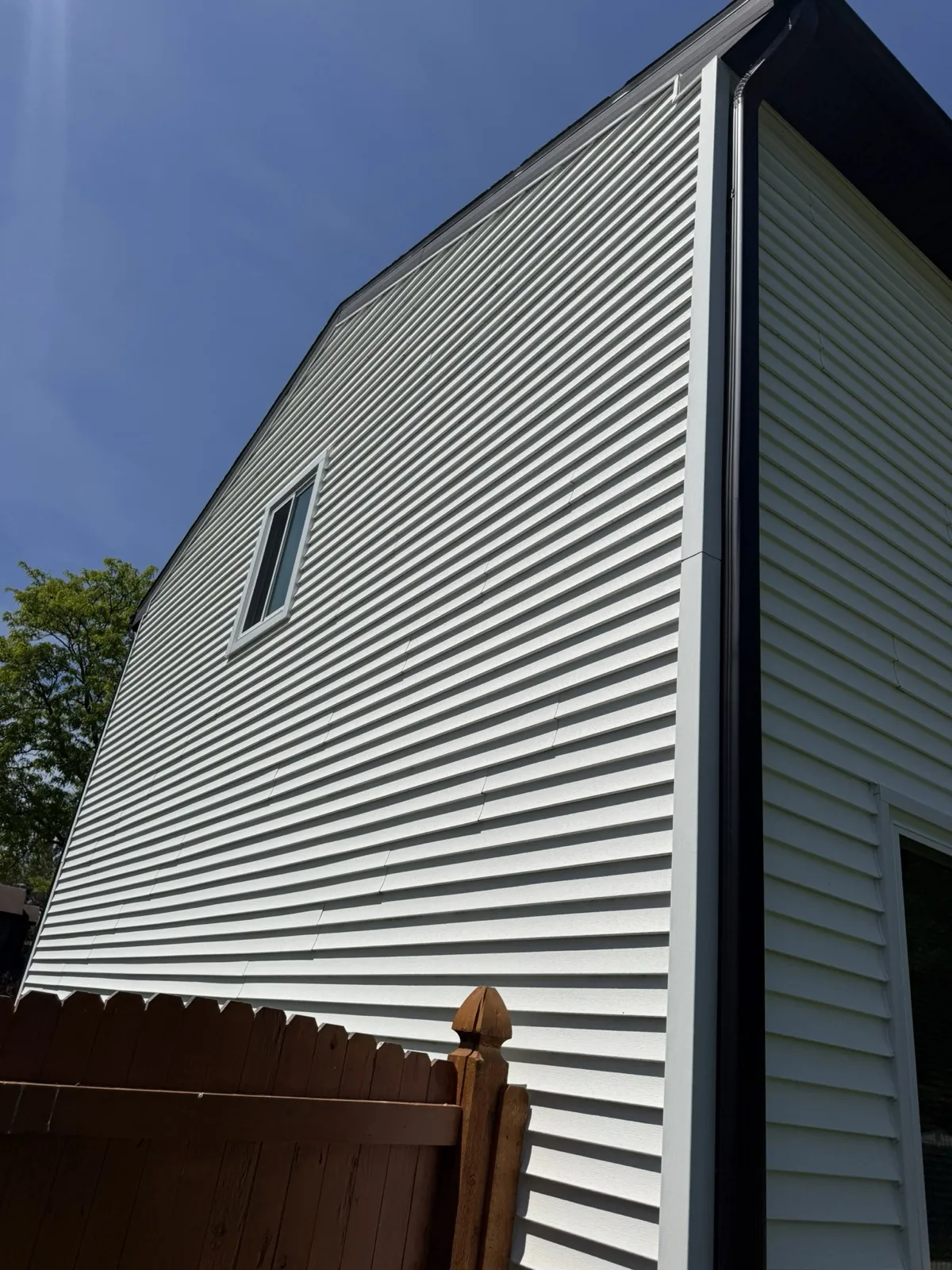 White vinyl siding installed on the side of a house in Westmont, IL