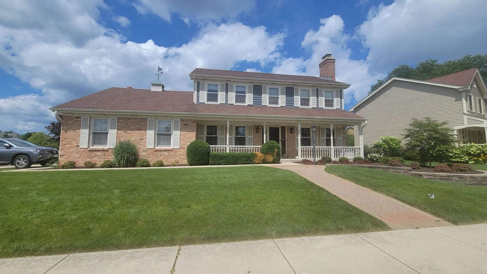 New brown architectural shingle roof on a two-story brick and siding home in Winfield, IL