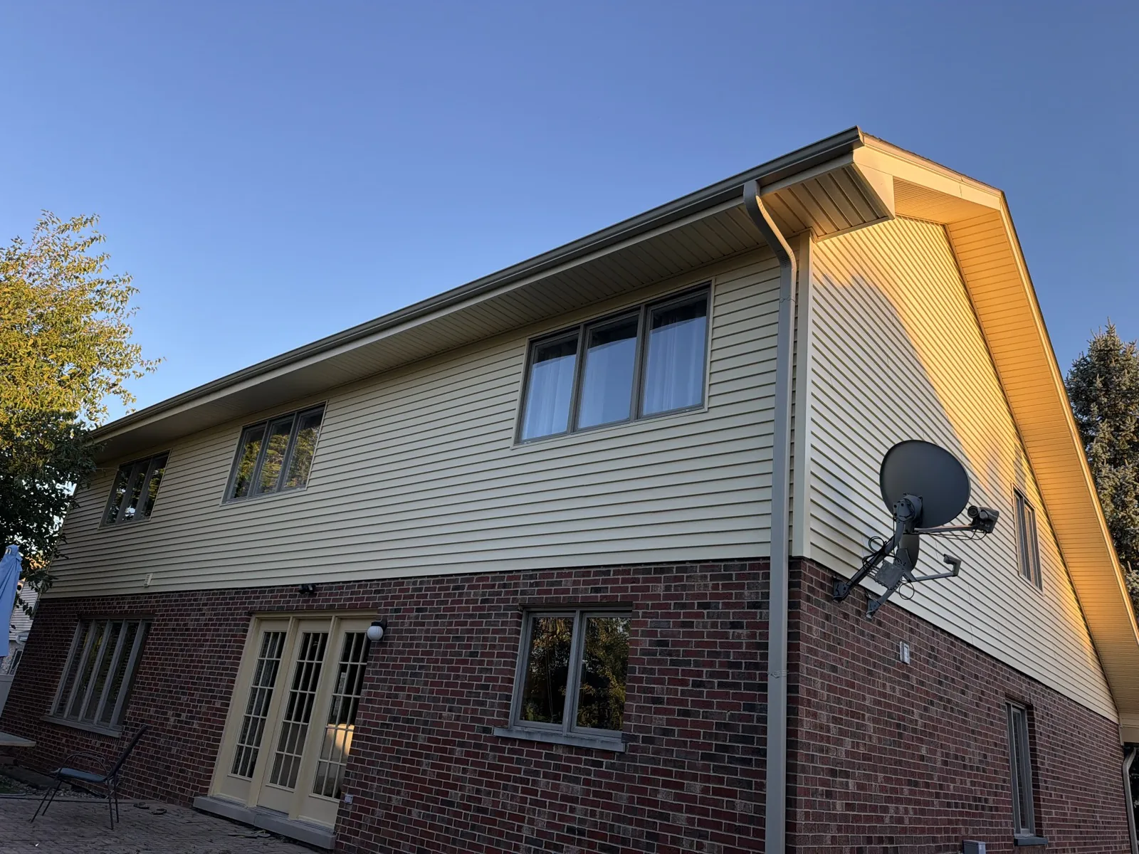 New beige vinyl siding and brick exterior on a two-story home in Woodridge, IL