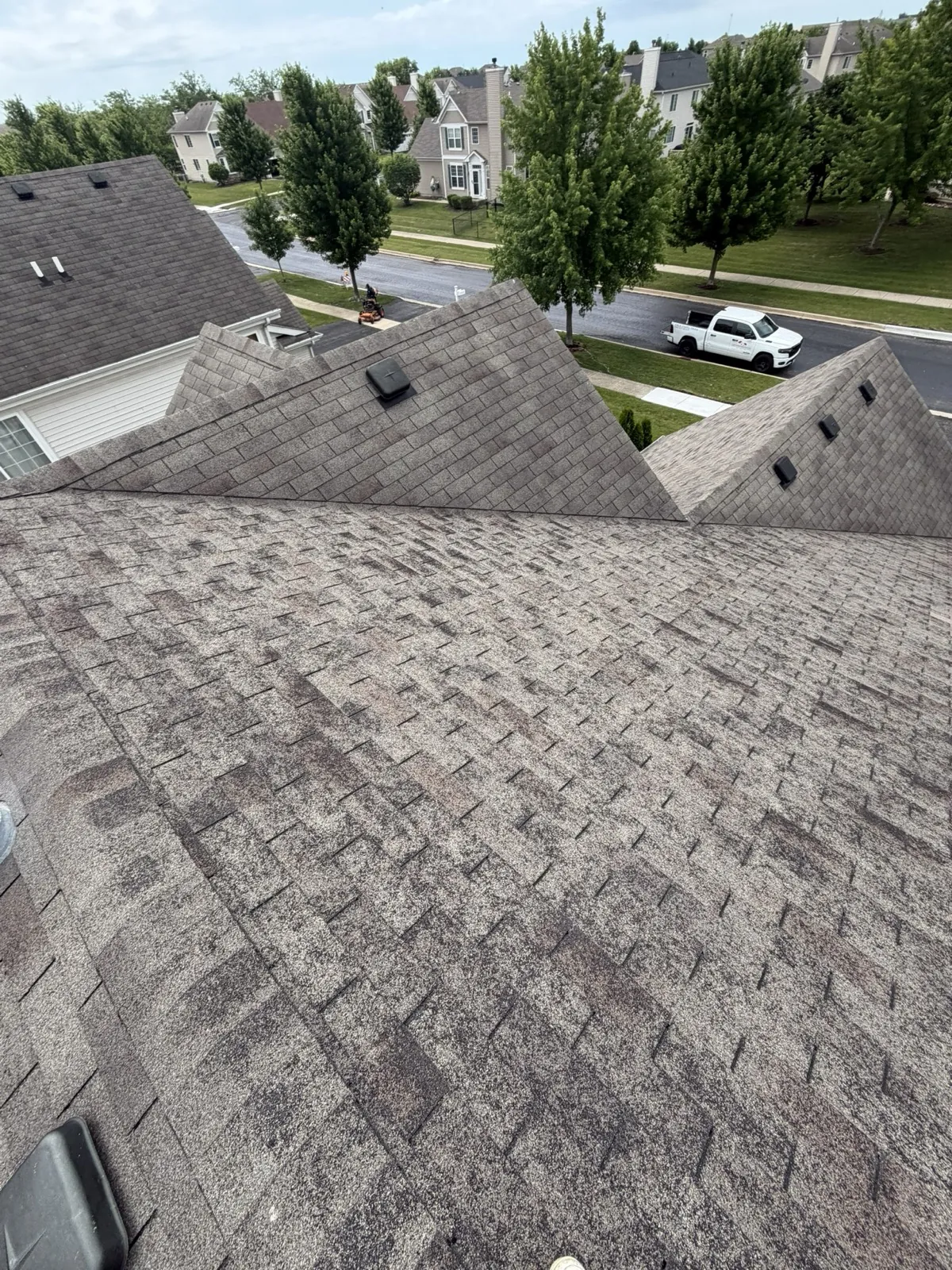 New gray architectural shingle roof on a multi-gabled home in Yorkville, IL